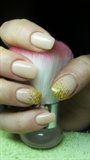 Nude (beige) nails with gold glitter