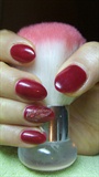Red nails with a feather