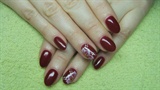 Dark red nails with a flower