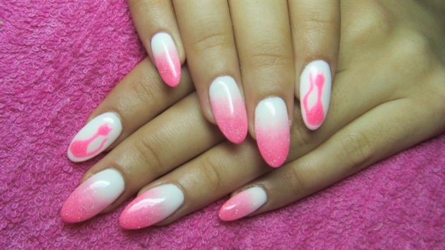 Pink and white ombre nails with a cat