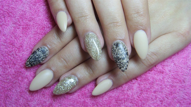 Beige stiletto nails with gold glitter
