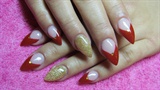 Red and gold stiletto nails