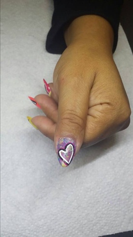 With white and black draw a heart and add glitter to the base of the nail. 